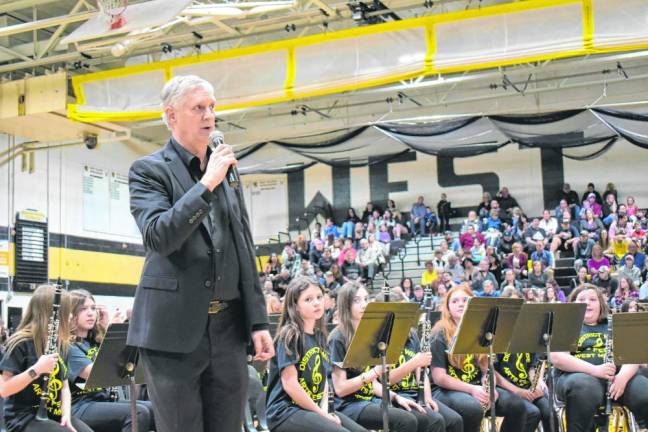 Brian McLaughlin, director of band at the high school, speaks during a performance the 10th annual All District Arts Festival on Wednesday, March 27.