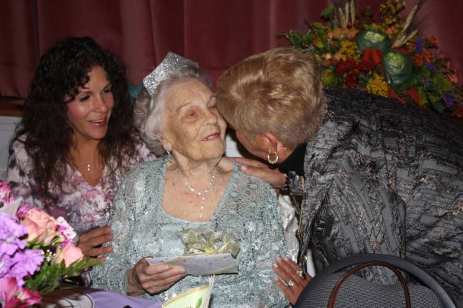 Elsie Powers is greeted by a friend Tuesday, with Mayor Bettina Bieri on left.
