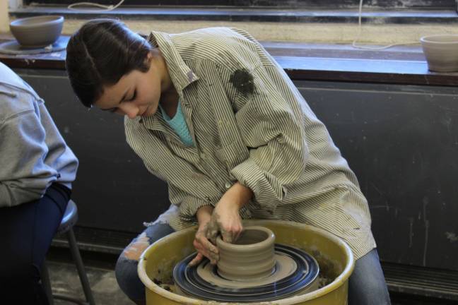 Glenna Dunlop makes one of the bowls that will be sold at Empty Bowls. Tickets must be purchased in advance.