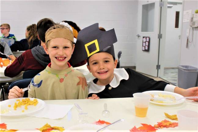 Second Graders Colin and Ethan enjoy the Thanksgiving feast at Ringwood Christian School Nov. 20.