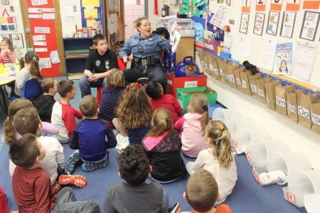 Officer Jill Brickman read to the students as part of their breakfast.