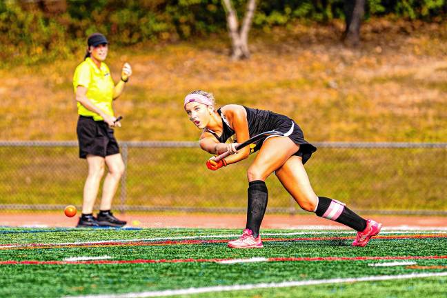 Ava Brock hits the ball to her teammate.