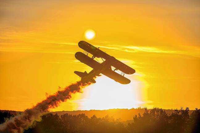 Third Strike Wingwalkers take off at sunset. (Photo by TJ Nolan)