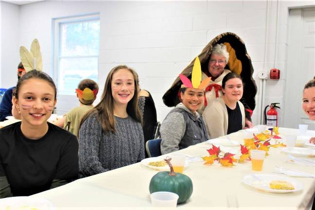 Dr. Furrey, school principal, with eighth graders, Stella, Rachel, Solenni, and Victoria, during the Nov. 20 Thanksgiving celebration at Ringwood Christian School.