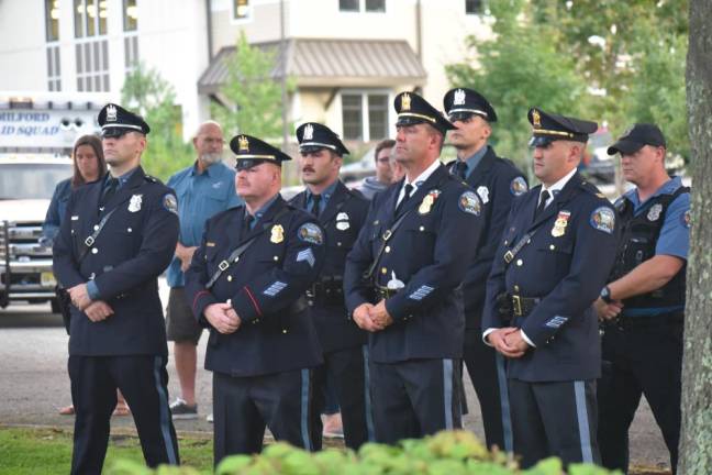 Police officers stand at attention during the ceremony.