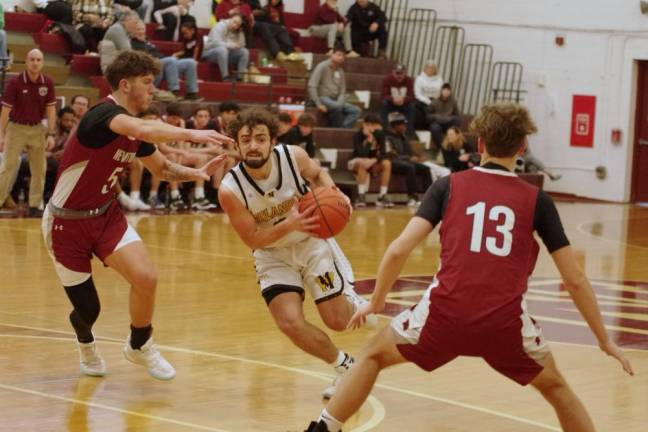 West Milford’s Dean Deaver maneuvers the ball between two Newton defenders. He scored 16 points.