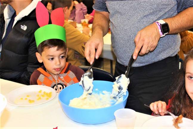 Submitted photos Kindergartener, Levi, is checking out the mashed potatoes during the Thanksgiving celebration.