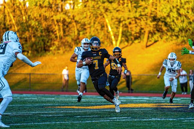 West Milford High School quarterback Aydin Deane runs the ball in the first quarter of the game against Passaic Valley at home Friday, Sept. 19. The Highlanders lost, 31-21. (Photos by TJ Nolan)