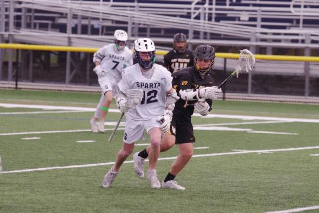 Sparta's Kurtis Cina with possession of the ball while being shadowed by West Milford's John Biegel.