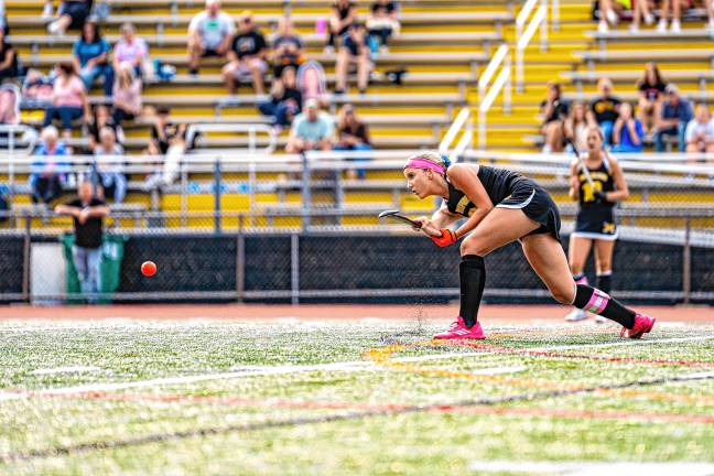 Senior Ava Brock passes to her teammate.