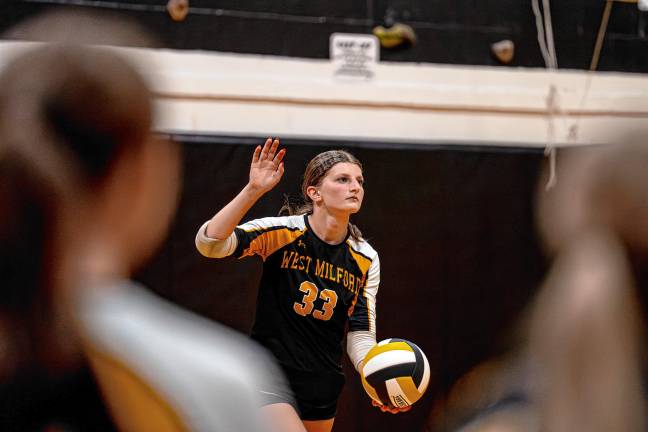 Senior Kailyn Schweighart steps up to serve.