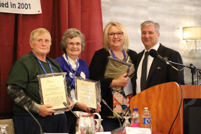 Councilwomen Ada Erik, left, and Marilyn Lichtenberg and Mayor Michele Dale accept an award at the Jersey Access Group conference in May. At right is Bob Duthaler, JAG president.