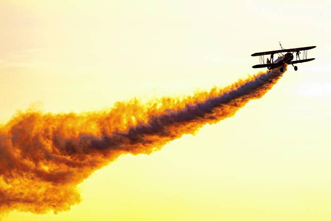 Third Strike Wingwalkers take off at sunset. (Photo by TJ Nolan)