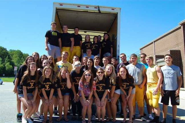 Football players helped the cheerleaders at last year's clothing drive.