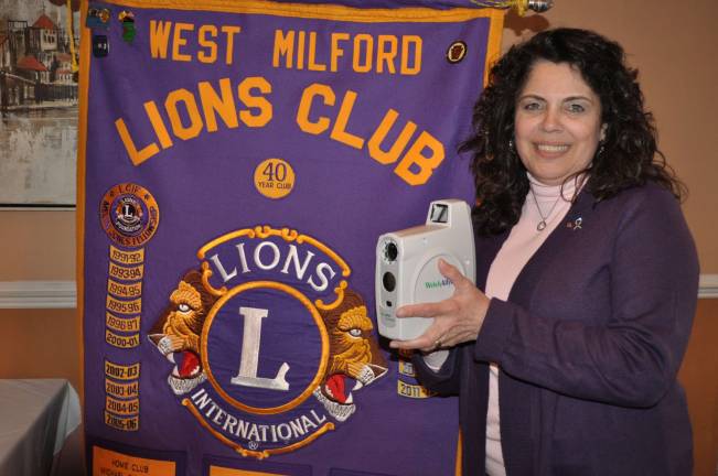 Barbara Cosaro of the West Milford Lions Club is seen with equipment used to screen young children for eye problems. Photo Courtesy West Milford Lions Club