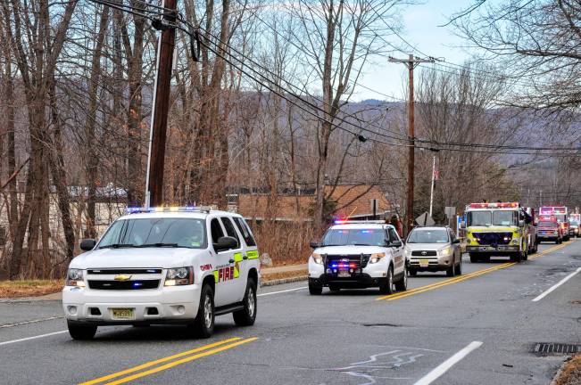 The cortege that carried Adrian Birdsall to his final resting place included his beloved fire fighters, police and EMTs.