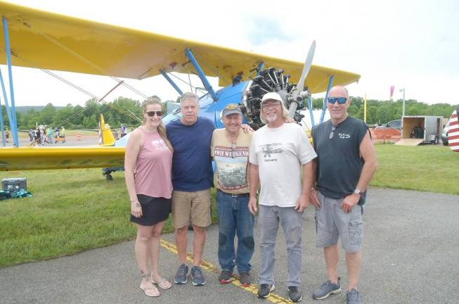 In front of their “Sterman Plane,” the pilot and crew from Warwick, NY airport who performed in the airshow were, left to right, Kellie, Mark Harrington, Ron Gertson, Fred Devens, and Andy Bender.