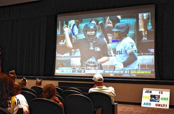 West Milford residents gather in the high school auditorium Sunday, Aug. 10 to watch Jen Pawol’s first call behind home plate as a Major League Baseball umpire. It was an inside strike from Braves pitcher Joey Wentz’ 93-mph fastball to catcher Sean Murphy with Miami second baseman Xavier Edwards.