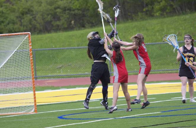 Caitlin Hanratty, the West Milford goalie, comes out to save a goal for the Highlanders.