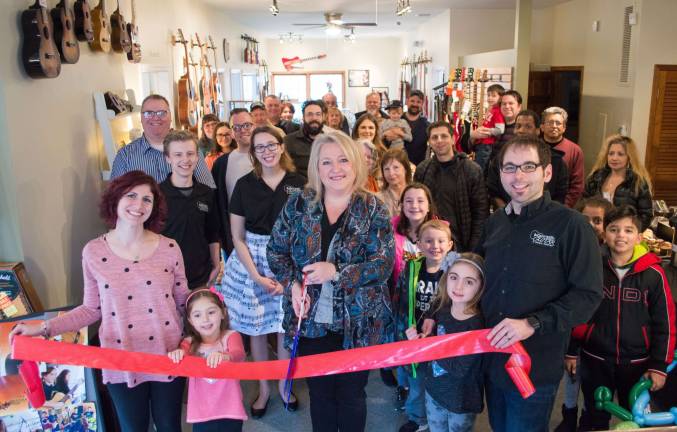 Submitted photo Mayor Michele Dale cuts the ribbon during the Grand Re-opening of North Jersey Guitar &amp; Music Center on Union Valley Road Dec. 2.
