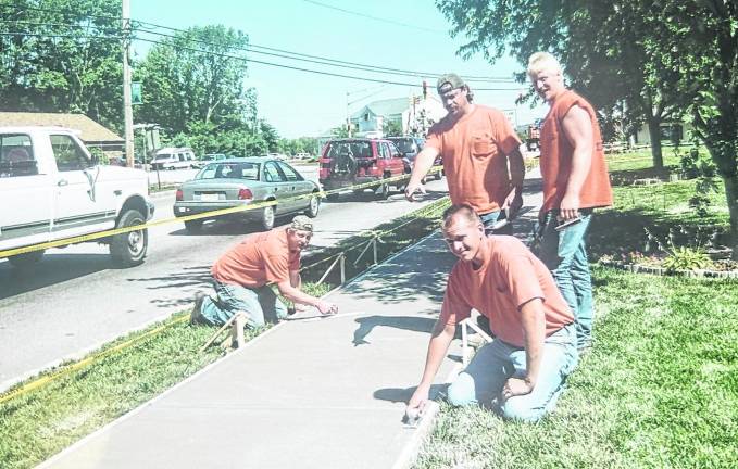 Men building a sidewalk along Union Valley Road in front of Veterans Park many years ago are Bob Vreeland, Roger Cox, Tim Vreeland and Anthony Adragna.