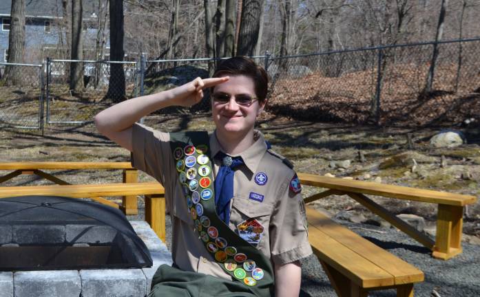 Peter Oselador sits by his Eagle Scout project on the property of St. Joseph Church.