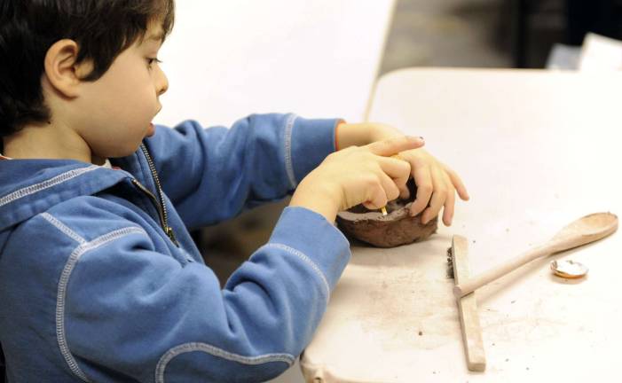 TAMARA BELL/STAFF PHOTOGRAPHER 1/10/09 Oak Park Isaac Schiff,6 makes a bowl at the Dole Art Center in Oak Park Saturday afternoon. Schiff said "I wanted to do pottery because my Mom took a class a long time ago and showed me how to make a few things"