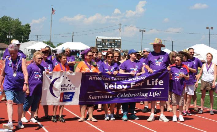 Photos by Ginny Raue By tradition, the first lap around the track at the Relay for Life of the Highlands is the survivor's lap, kicking off the event with many broad smiles and cheers from the on-lookers.