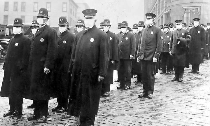 Policemen in Seattle wearing masks made by the Red Cross, during the influenza epidemic. December 1918.