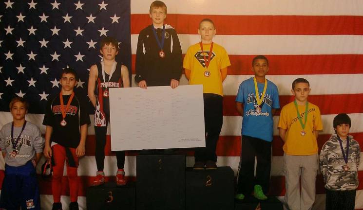 Jordan Robinson placed fourth at the state championships for youth wrestling. He is pictured here third from right.