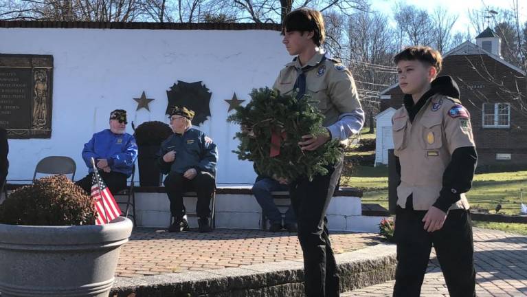 Boy Scouts and brothers Daniel, 15, and Ryan Bauer, 12, prepare to place a wreath in honor of the Merchant Marines.