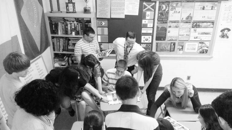 Greg Matlosz, pictured with tie, oversees the students who were working on the military alumni project. This year's students will continue updating the Web site.