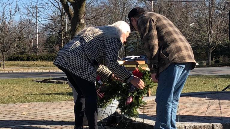 Residents place wreaths in honor of each branch of the military.
