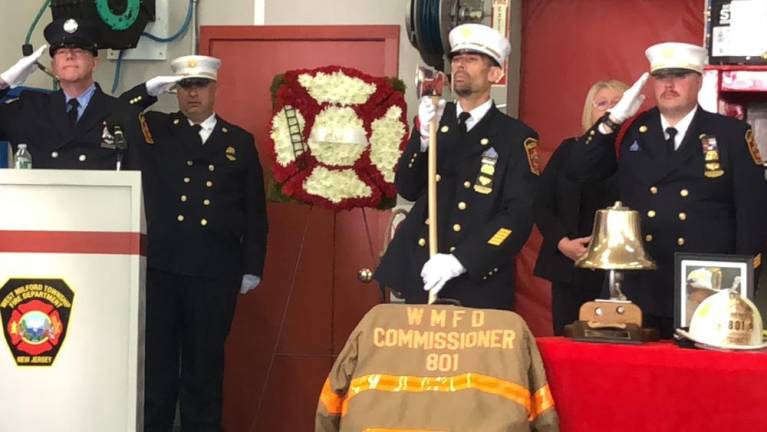 Fire officials salute during the memorial service for Fire Commissioner Edward Steines, who died Aug. 16.