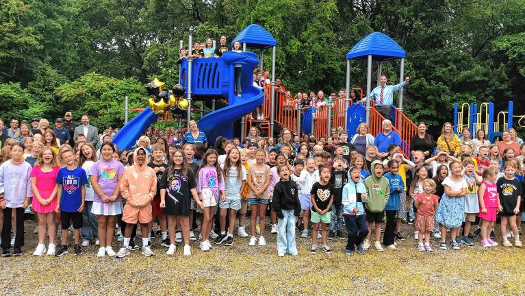 Students at Upper Greenwood Lake Elementary School gather for a ribbon-cutting ceremony to mark the opening of new playground equipment Friday, Sept. 5.
