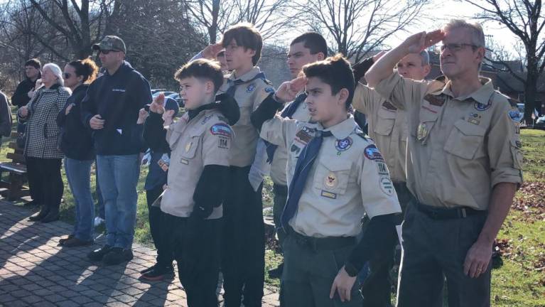 Members of Boy Scouts Troop 114 salute during the ceremony.