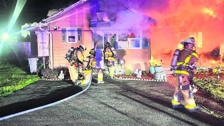 Firefighters on the scene at a house fire on Elm Street.