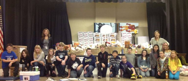 West Milford is a giving town. Here, students from Upper Greenwood Lake Elementary School survey the food baskets they put together for those in need for Thanksgiving.