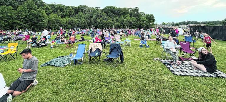 The crowds sat down at the field before the fireworks.