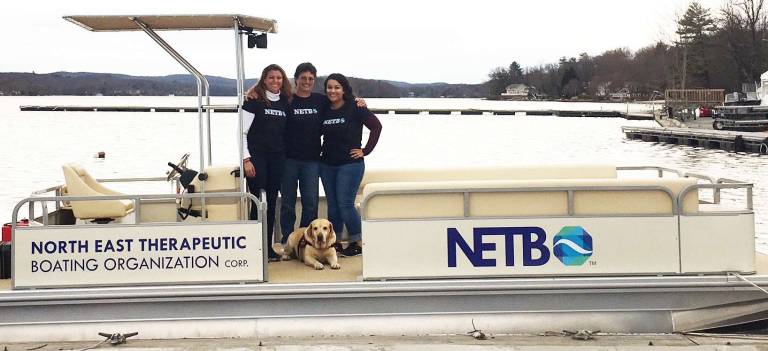 Source: netbo.org Rebecca Dykstra, left, her mom and owner of Greenwood Lake Marina Elena Dykstra and Kaylin Aditya are ready to launch North East Therapeutic Boating. Ella, in front, is ready to go too.