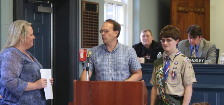 Photo by Linda Smith Hancharick Peter Oselador, left, stands with his dad Peter and Council President Michele Dale at the June 8 meeting of the township council. Peter was recognized for attaining Eagle Scout status.