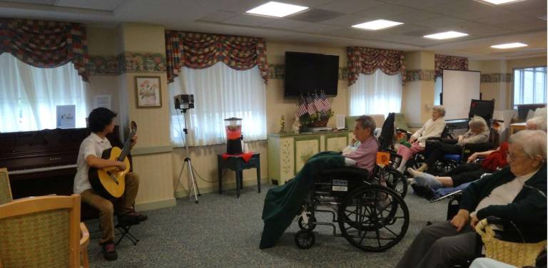 Max Marra is shown here playing for the elderly at Renaissance Gardens in Cedar Crest Village recently. Max will perform at Music at the Mission this Saturday. He is collecting donations to help with expenses for a mission trip this summer.