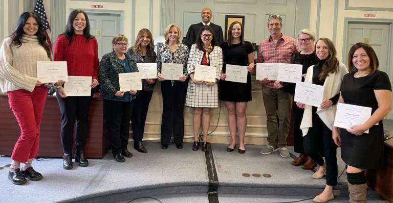 From left are Jeanette Schneider, Vanessa Patterson, Theresa Wislomerski, Helen Vera, Kelly Volpi, Teresa LeDonne, Kathleen McCarty, James Hubertus, Laura Evans-Harty, Carolyn Asch and Raquel Tumminelli. Behind them is Judge Michael Paul Wright, who swore in the CASA volunteers Dec. 8. (Photo provided)
