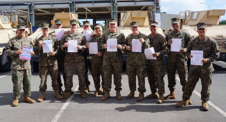 Holding the letters from PK students, are, from left, Sergeant Tony Ruiz, Corporal Matthew Gartland, Sergeant Anthony Cathers, Corporal Justin Edelbach, Corporal Caleb Bodjanac, Lance Corporal Brady Solmon, Corporal James Csoka, Lance Corporal Dylan King, Lance Corporal Johnathan Orellano, Private First Class Caleb Prescott and Corporal Joseph Afanador.