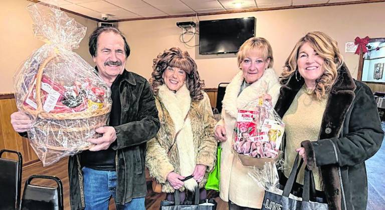 Frank DeCarlo, and his wife Nadine DeCarlo, Jody Mullet, Kelly Williams are shown with items they won.
