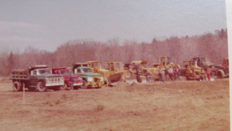 PHOTOS BY ANN GENADER West Milford contractors are seen with their heavy equipment machines and trucks about 40 years ago - ready to start their volunteer project to build San Cap ball fields.