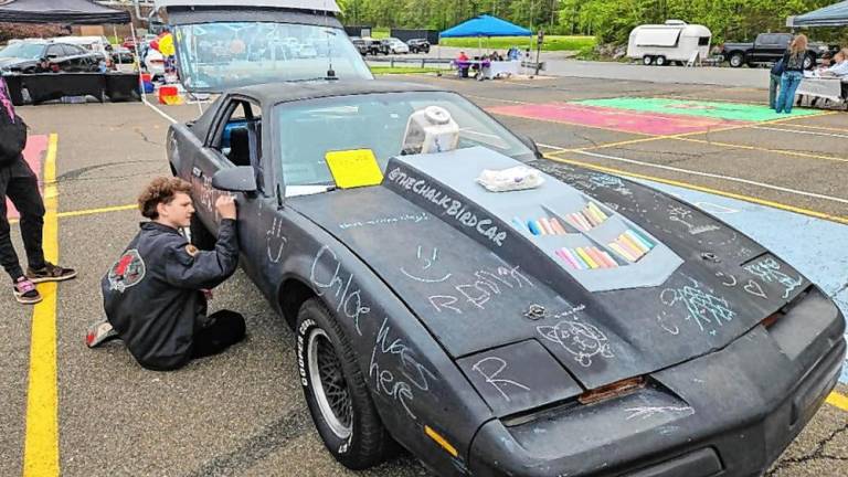 People were invited to draw or write on the Chalk Bird Car at the second annual Car Show, Food Truck and Vendor Fair on Saturday, May 4 at West Milford High School. (Photo by Rich Adamonis)