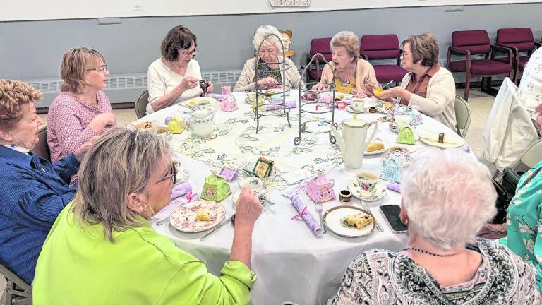 Women in elaborate hats and spring garb gathered at the West Milford Presbyterian Church’s annual Tea on April 18 for a traditional British tea and tricky tray. The tea is a fund raiser for the church’s various local service initiatives.