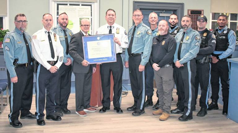 Representatives of the West Milford Police Departmentwere on hand to accept the New Jersey Association of Chiefs of Police accreditation designation during the Town Hall meeting on Wednesday, Nov. 12. Holding the official Accreditation Certificate are (center, left to right) Association Program Director, Harry Delgado, and WMPD Chief Shannon Sommerville.