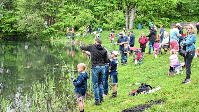 Nearly 100 children and adults try their luck at the annual Kids Fishing Derby on Saturday, May 17. (Photos by Rich Adamonis)